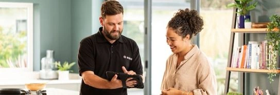Installer with customer looking at a tablet